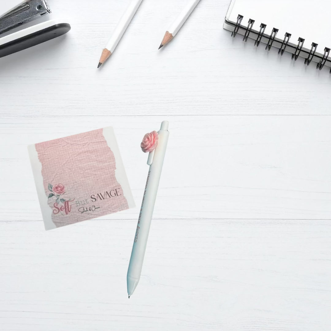 White desktop with sticky note pad andpen.