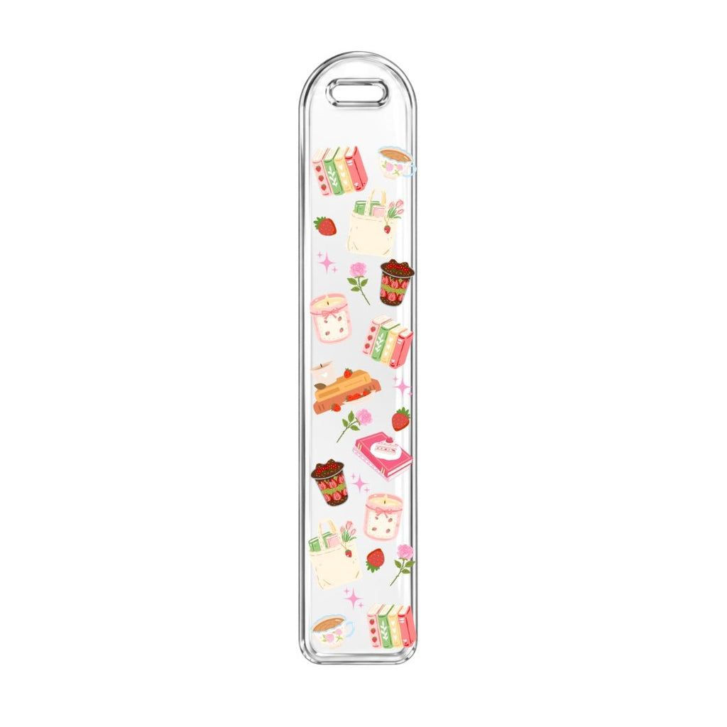 Clear acrylic bookmark featuring strawberries, books, cozy drinks, and colorful reading accessories