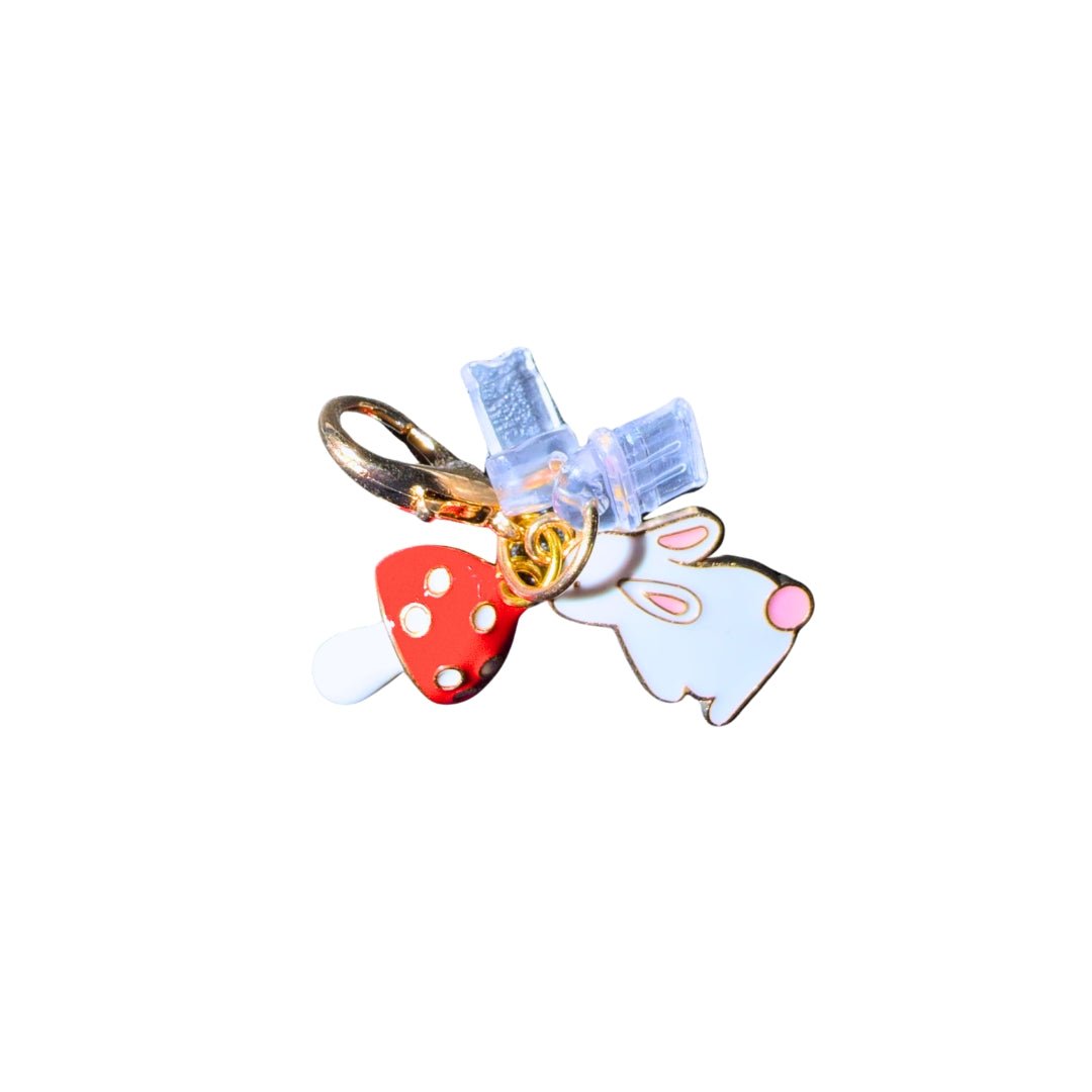 Rabbit and mushroom phone dust plug charm with white bunny, red mushroom and interchangeable charging port covers.