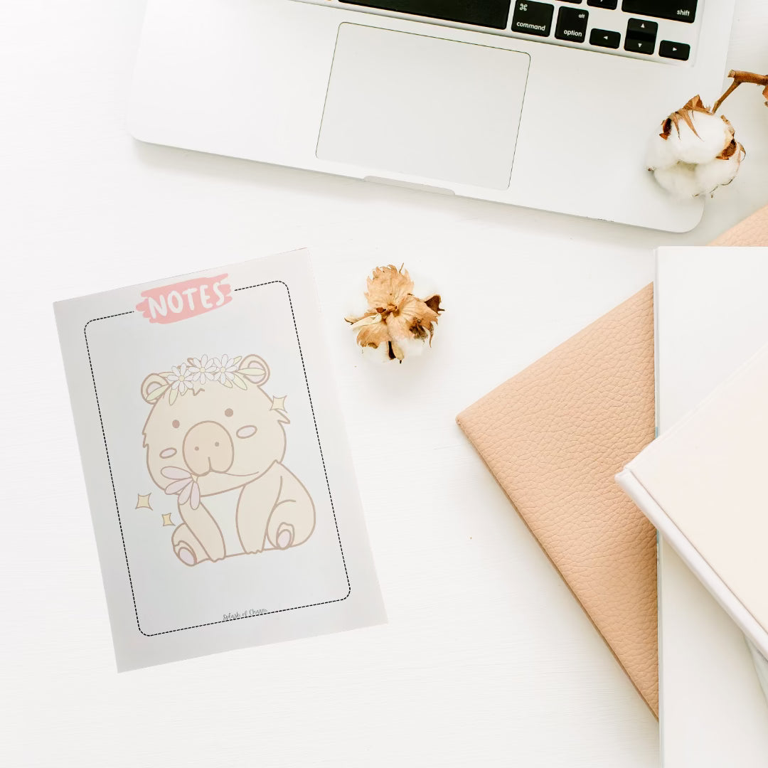 Hippie the Capybara 5x7 notepad with floral design on desk setup