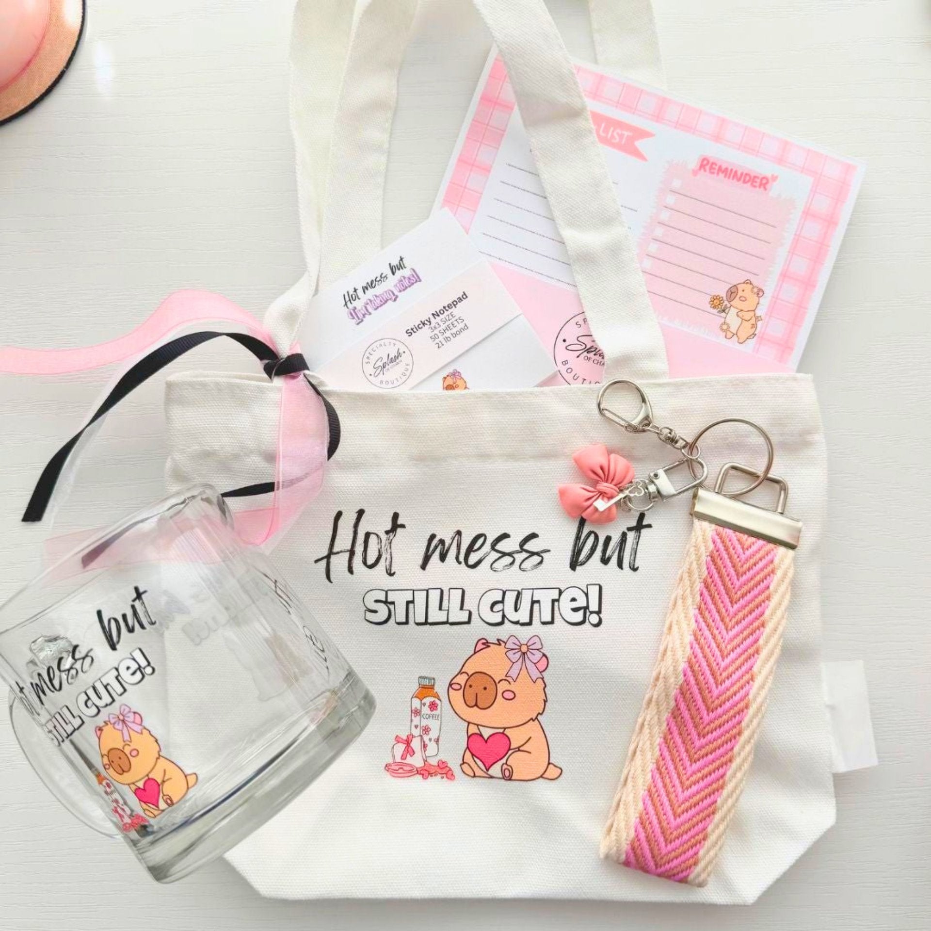 Hot mess era capybara gift bundle with tote bag, glass mug and aesthetic desk setup lifestyle scene