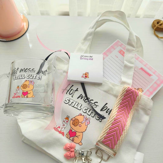 Close up of hot mess capybara mug, tote bag and stationery gift bundle items