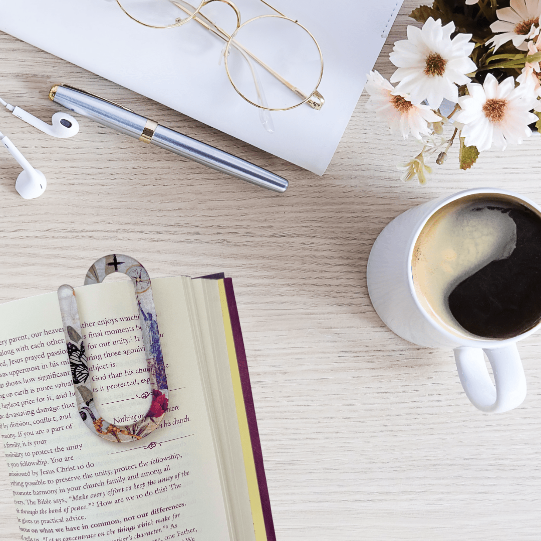 Jumbo acrylic paper clip bookmark with floral faith design clipped onto book page