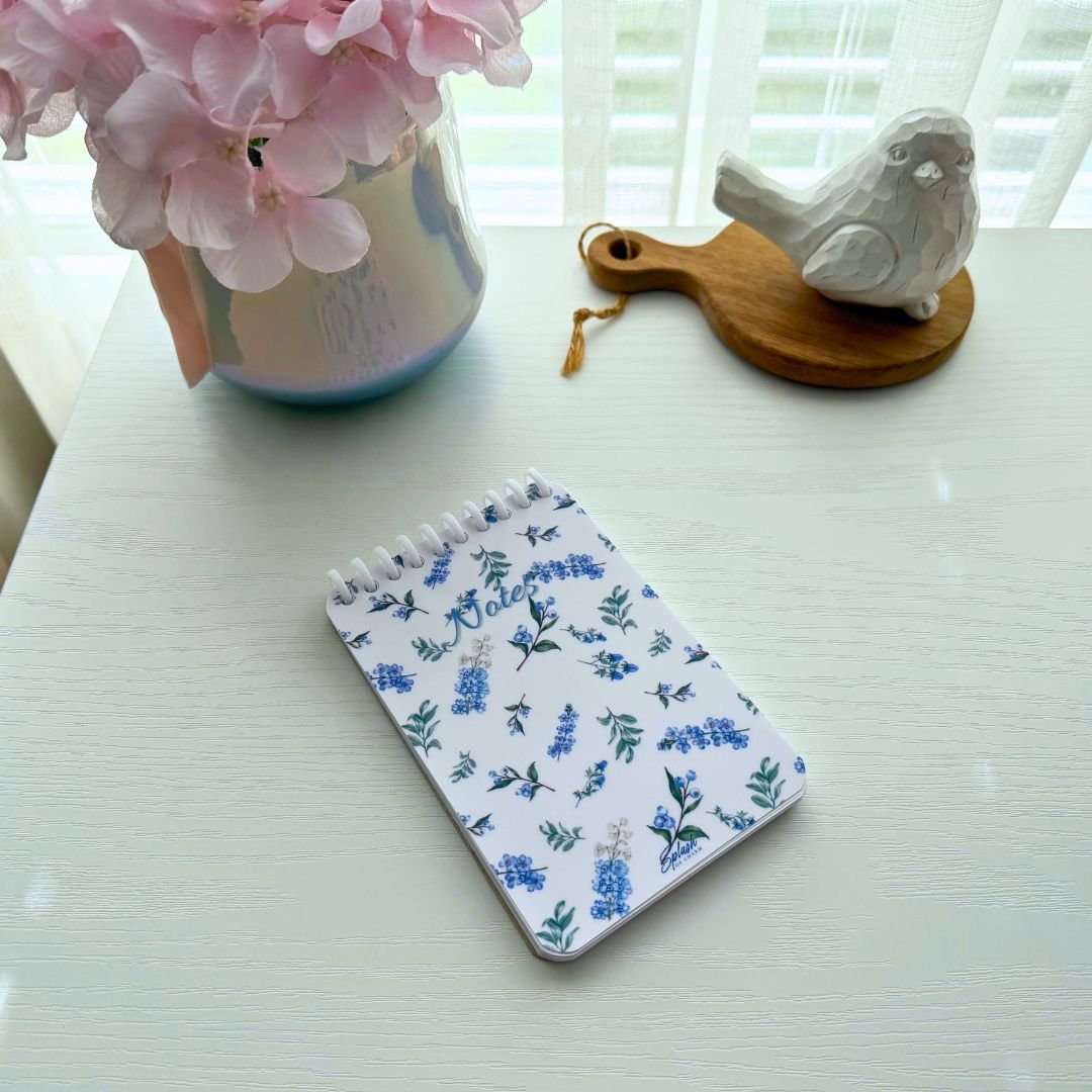 Lavender floral 4x6 spiral desk notepad styled in a soft life workspace with pink flowers and calming decor