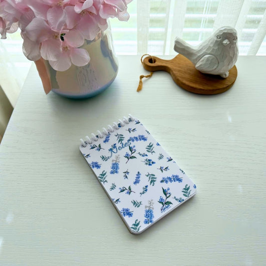 Lavender floral 4x6 spiral desk notepad styled in a soft life workspace with pink flowers and calming decor