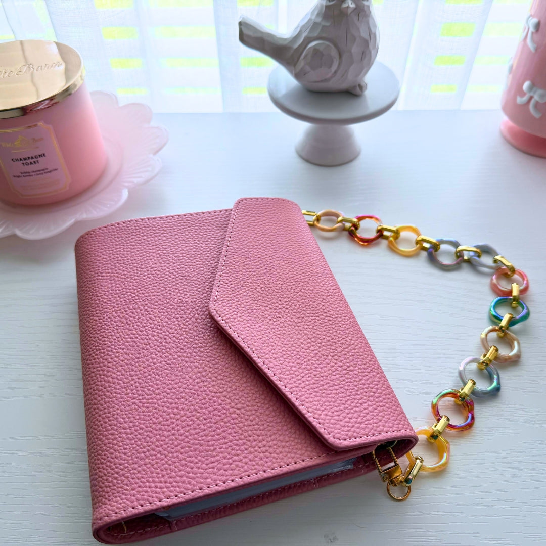 Pastel marbled acrylic purse strap attached to a pink Bailey Clutch organizer with gold hardware for a colorful interchangeable handbag accessory.