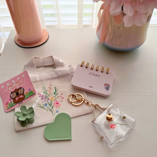 Tiny Tote Self-Care Bundle styled with mini tote, notepad, hair clip, charm accessories, and cozy pink aesthetic