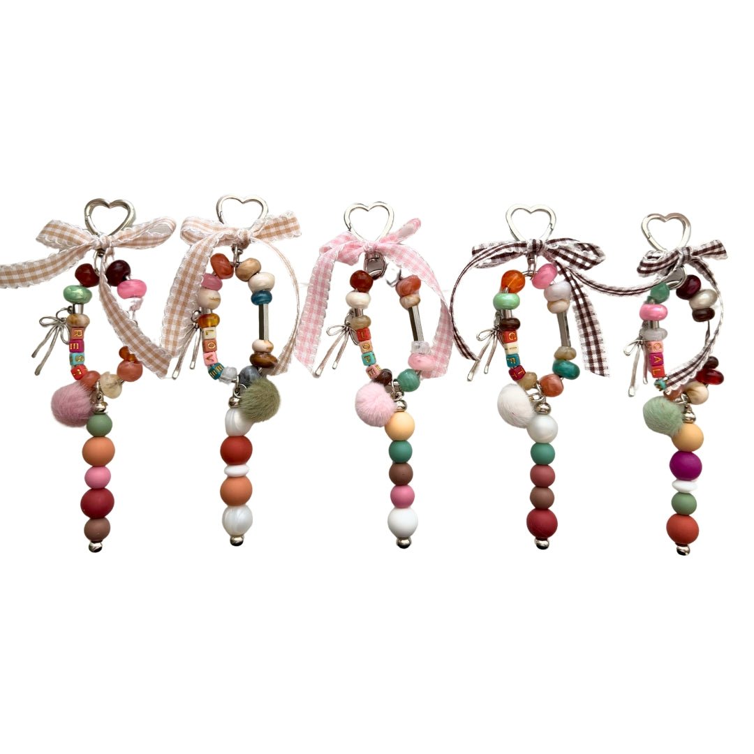 Five Word Story beaded bag charms in GIFT, HOPE, REST, CALM and LOVE designs